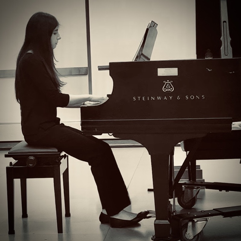 Nika playing a Steinway & Sons grand piano